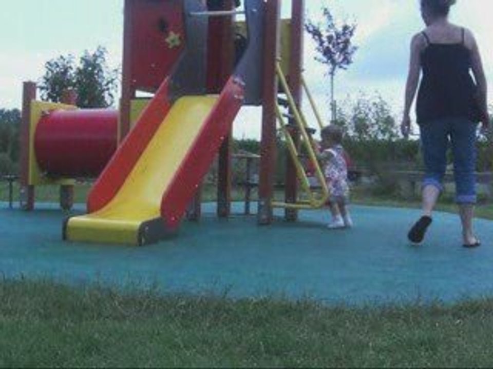 Comme une grande au tobogan sous la surveillance de maman