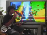 Kid Solves 2 Rubik's Cubes While Playing Guitar Hero