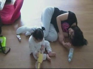 Baby Mideum is laughing at a rubber chicken