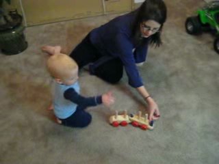 baby boy and mommy playing with choo choo train