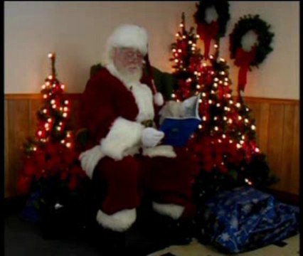 Santa Claus reading Twas The Night Before Christmas