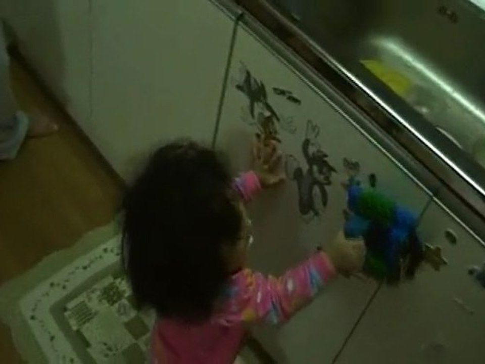 Baby Mideum playing with a toy train (Oxford Toy)