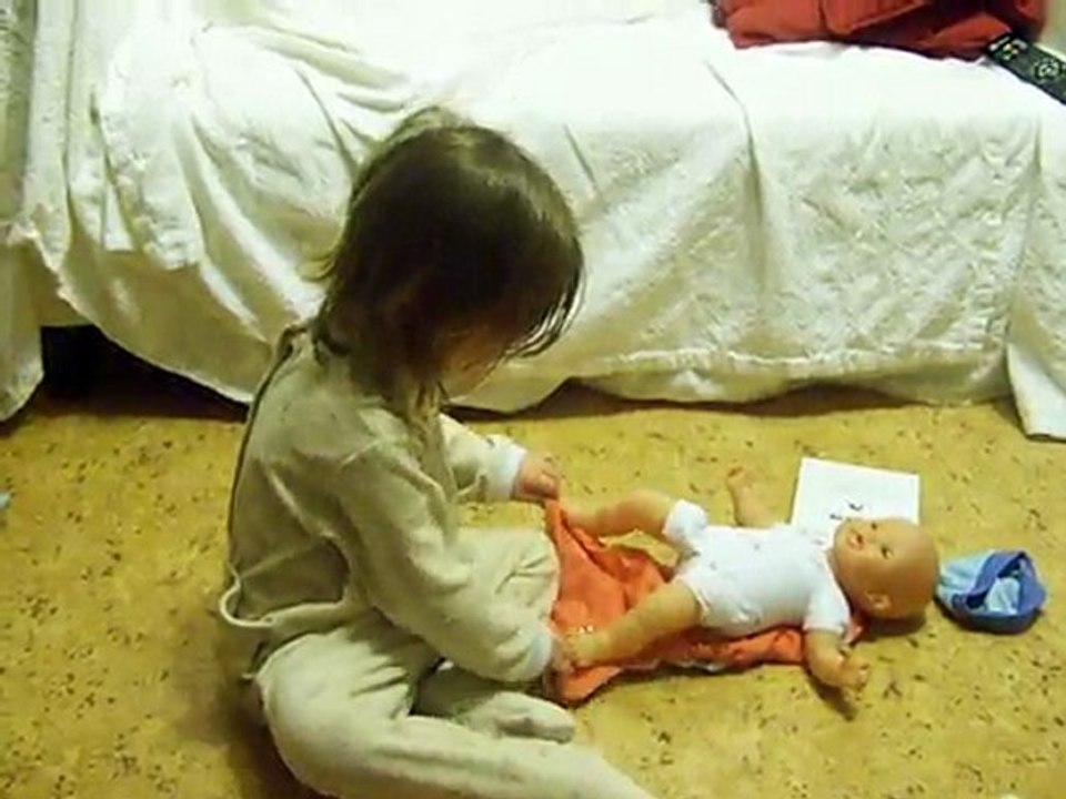 Marie essaye de mettre une couche à son bb