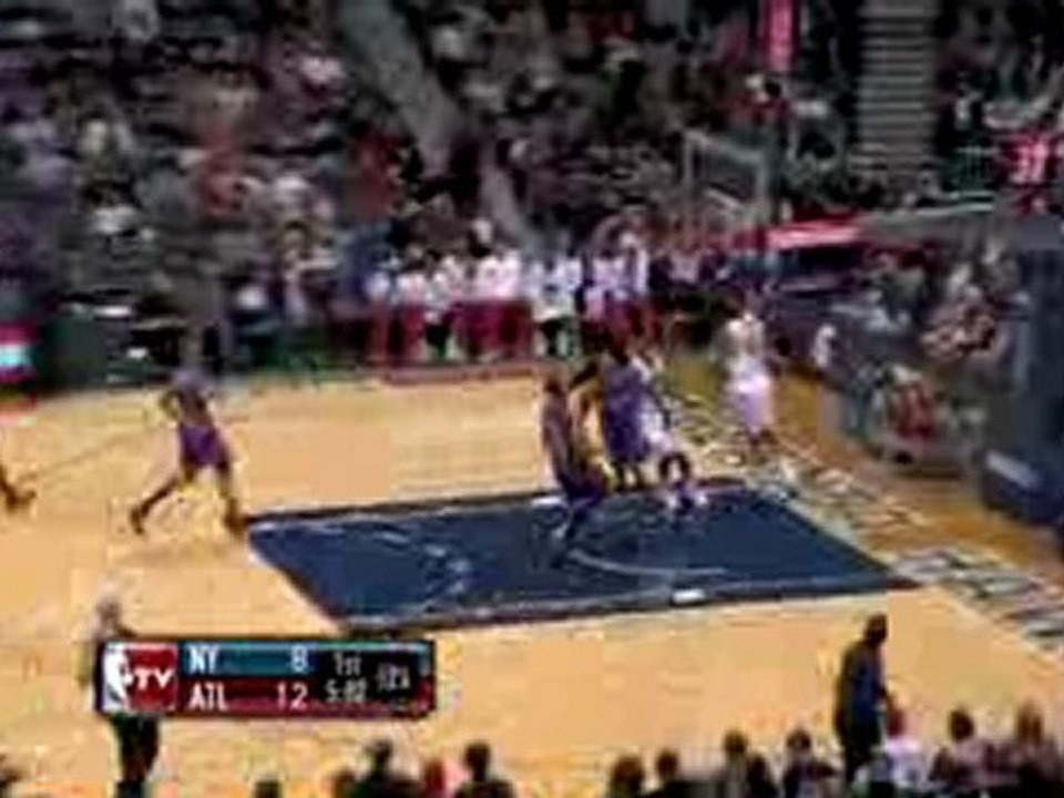 NBA Josh Smith blocks a shot at the rim.  Joe Johnson passes