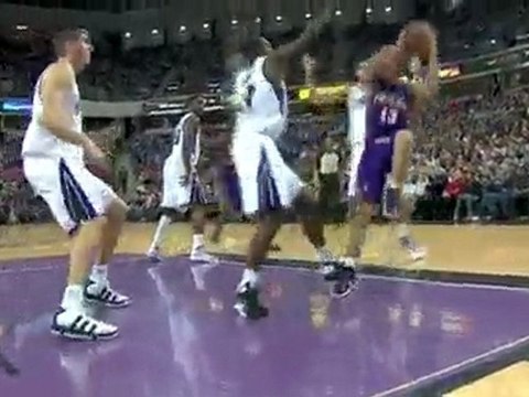 Steve Nash drives the lane and somehow manages to get this s