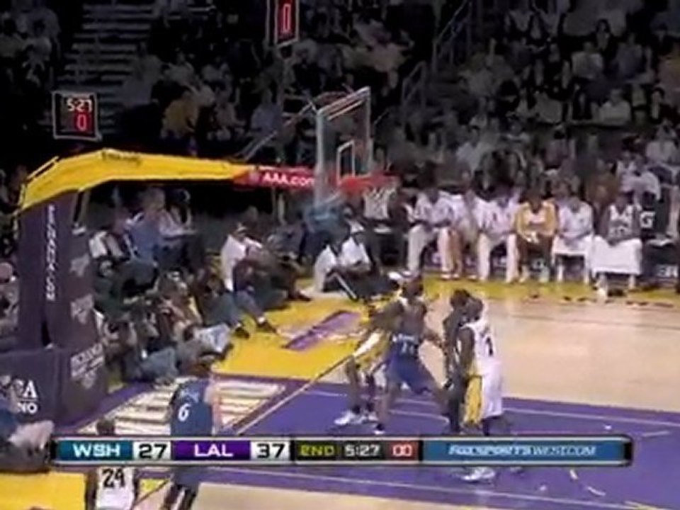 Kobe Bryant buries a tough jumper with a hand in his face.