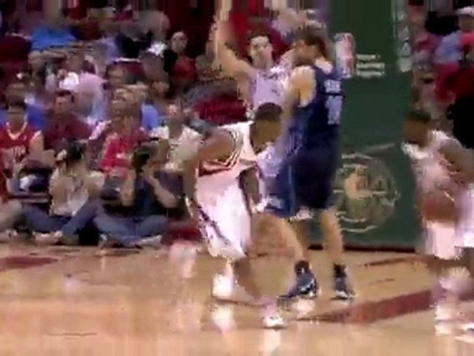 Aaron Brooks heads down the court off the Trevor Ariza still