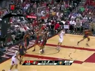 Rudy Fernandez drives down low and goes up with his left han