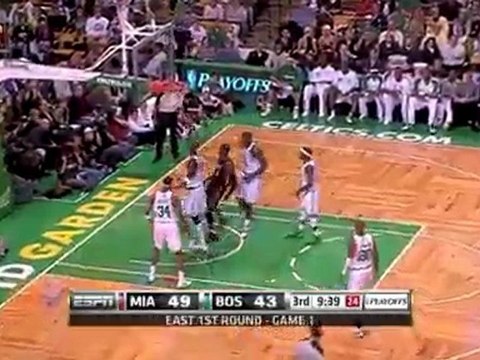 Dwyane Wade puts back the miss with a two-handed dunk.