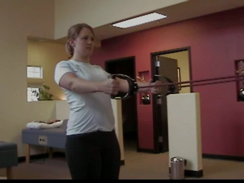 Pewaukee Chiropractic Demos a Back Exercise