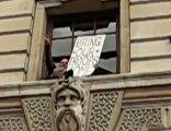 Protester scales treasury building - London UK