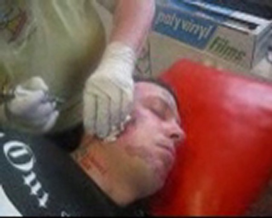 Billy the billboard getting a tattoo of Cam4 on his face