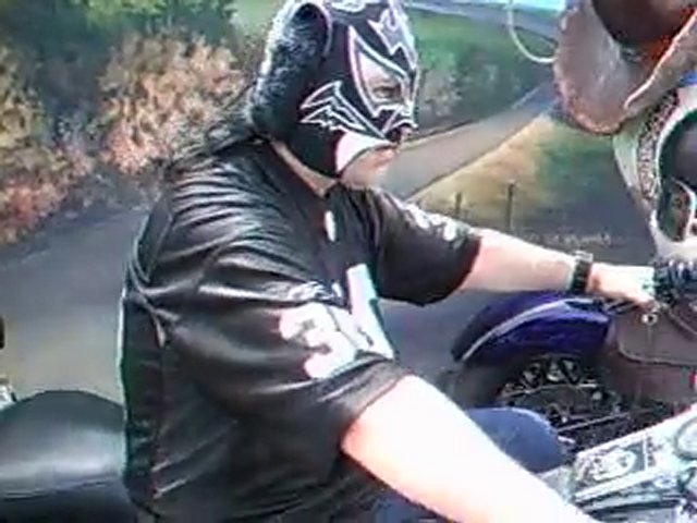 masked man & bear on motorcycles.