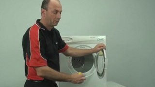 Changing a door hinge on a tumble clothes dryer