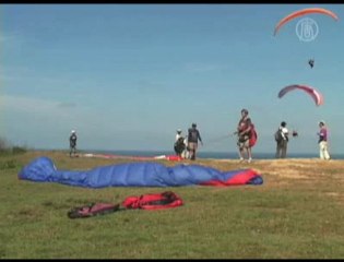 Download Video: Tourists Enjoy Paragliding at Bali, Indonesia Beach