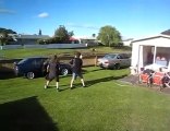 Four grown men jump through a hula hoop