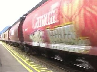 Freight train passing through Banff station in Canada
