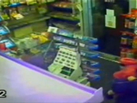 Robbers cocked gun at shopkeeper cradling child