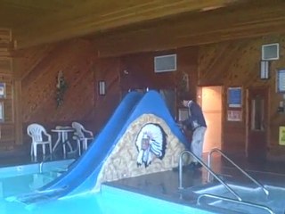 Going down a pool slide with clothes on