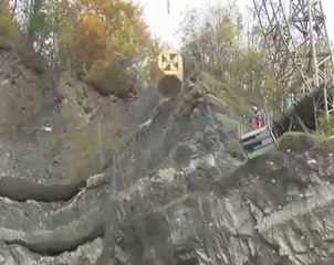 Vertical rockfall testing of high energy barrier