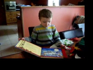 Benjamin opening the Christmas book read by Aunt Kim