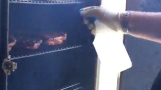Scottie Johnson sprays ribs at Shannon BBQ Contest