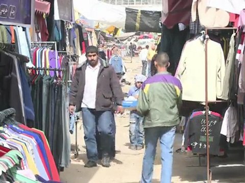 Arabic-Web-Strapped Gazans buy Israeli cast-off clothes