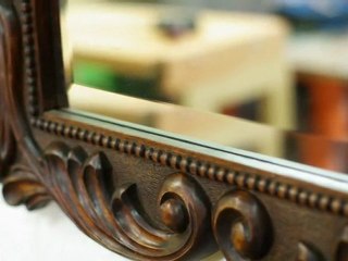 Carved mirror frame by Radu Man