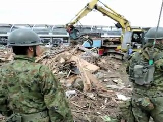 Soldiers try to clean up devastated Sendai airport