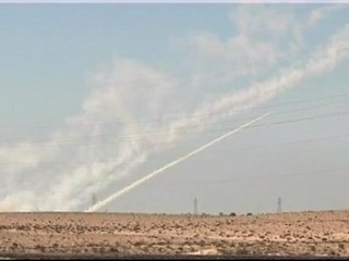 Libya rebels fire rockets from trucks