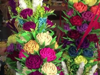 Giant flower-festooned poles mark Palm Sunday in Poland