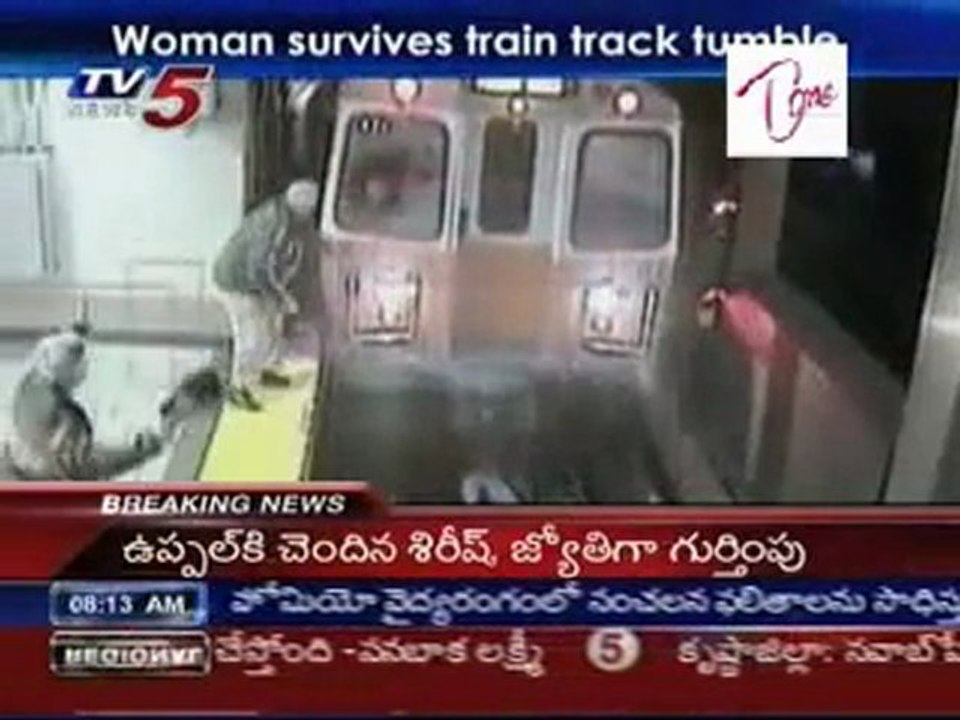 Woman survives train track tumble