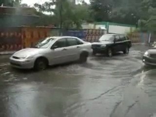 Sewer geyser lifts car