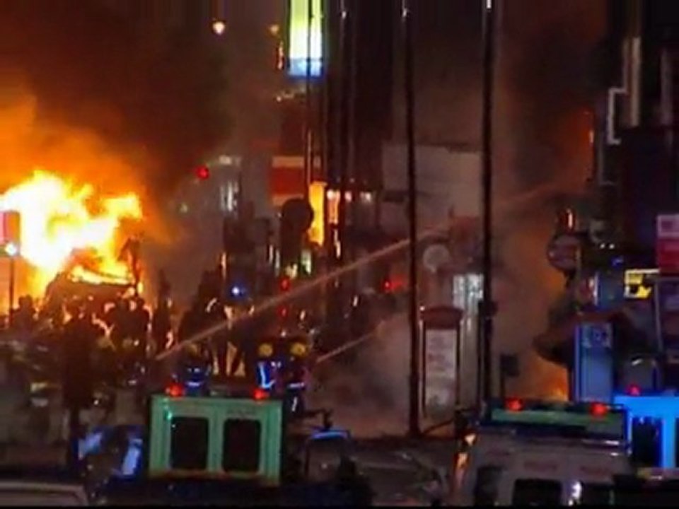 Rioters torch police cars in Tottenham