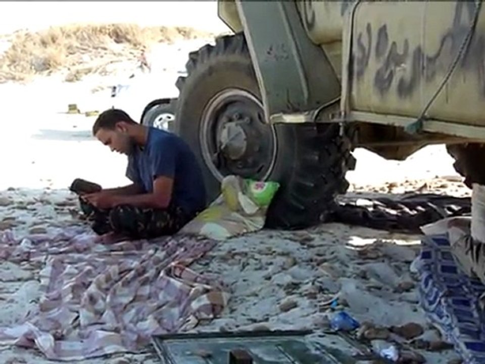 Libyan rebels wait at the doors of oil hub Brega