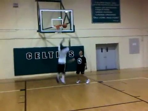 Coach shatters backboard with slam dunk