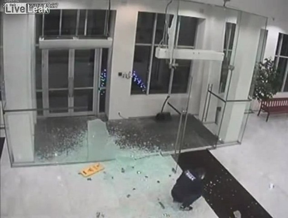 Man Walks Through Glass Entrance
