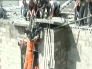 Caught on camera: Dramatic rescue of man dangling from roof of 3-storey building