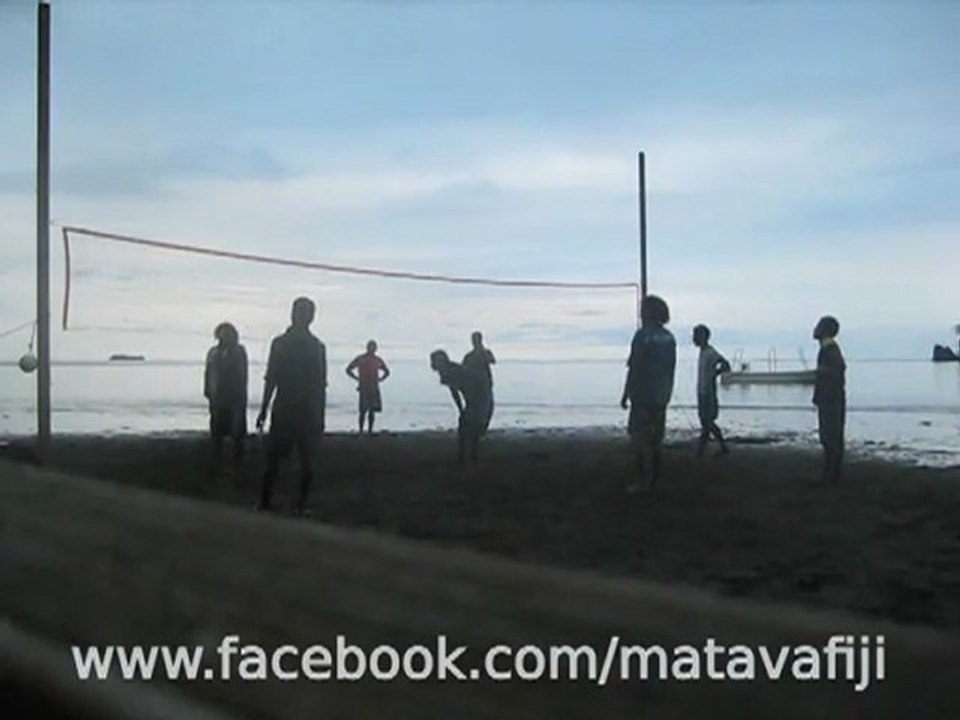 Matava staff laughing and playing volleyball on beach