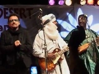 Bono dances amongst the desert dunes