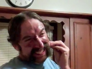 man pulling out own facial hair