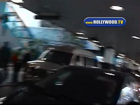 Fergie Hides from cameras as she arrives at LAX