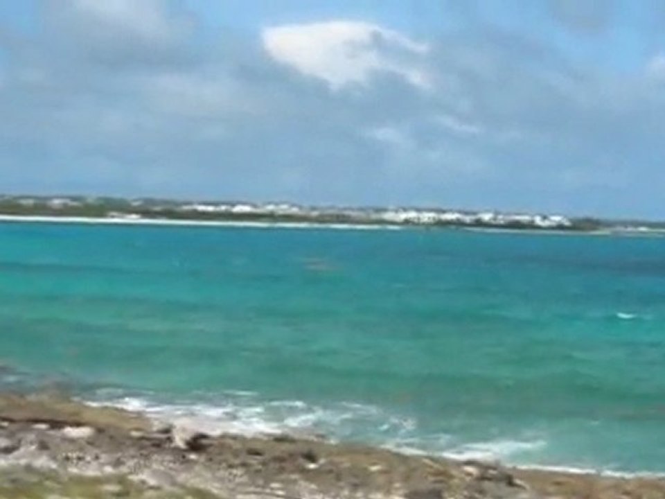 Cove bay in Anguilla and a distant view of Saint Martin (French side)