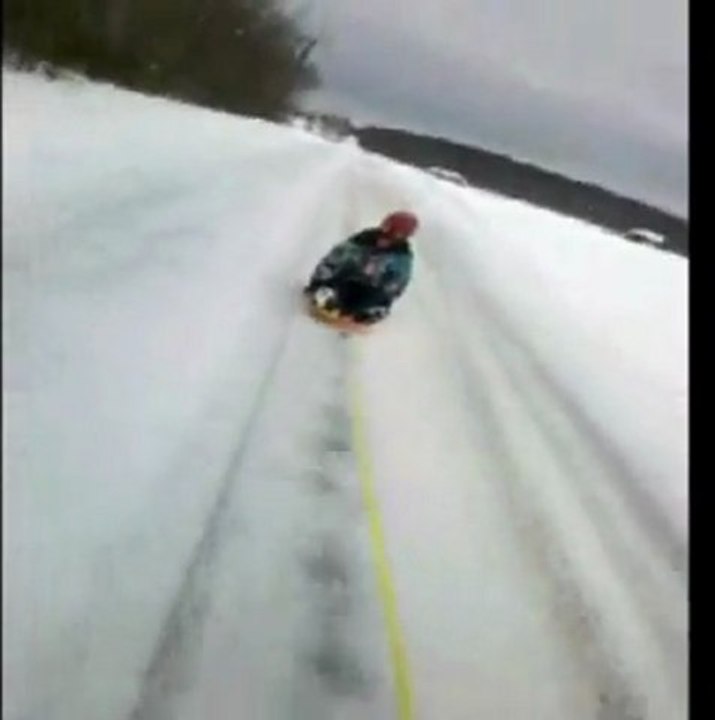 Sledding girl owned by dog