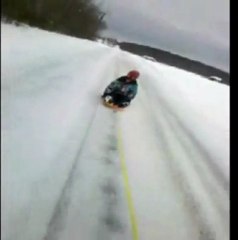 Sledding girl owned by dog