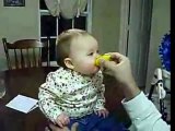 Baby eats a sour lemon