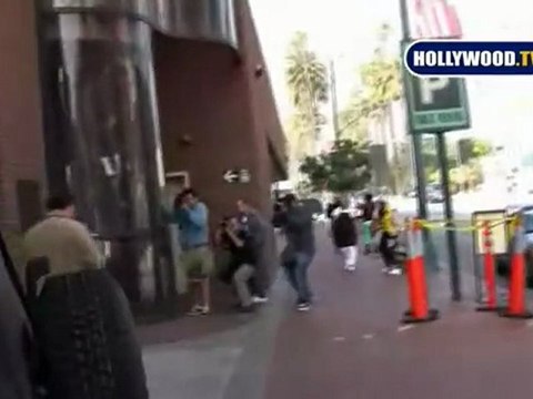 Jim Belushi stares at Blackberry and tries to walk