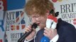 Ed Sheeran speaks in the winner's room at the Brits