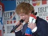Ed Sheeran speaks in the winner's room at the Brits