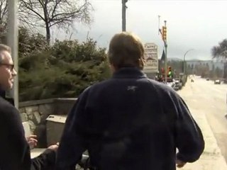 TV reporter walks into sign post